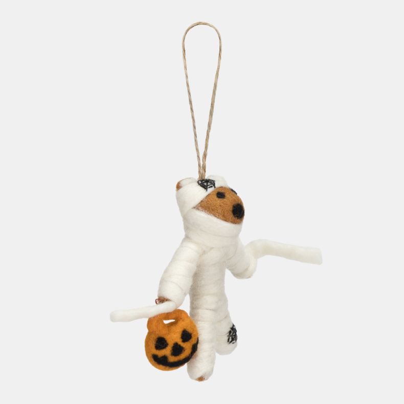 Felt mummy hanging decoration shown from the side, crafted with white wrapped felt detailing and carrying an orange pumpkin trick-or-treat bucket. Finished with stitched black accents and a natural hanging loop, this playful Halloween ornament is ideal fo