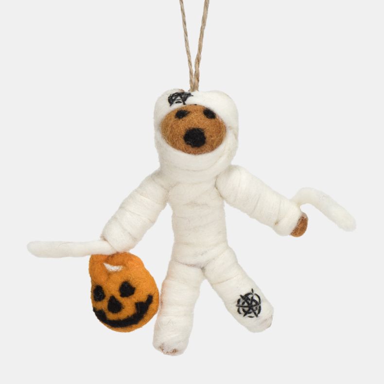 Felt mummy hanging decoration carrying an orange pumpkin trick-or-treat bucket. Crafted from white felt with wrapped mummy-style detailing, stitched black accents, and a natural hanging loop, this playful Halloween ornament is ideal for seasonal displays,