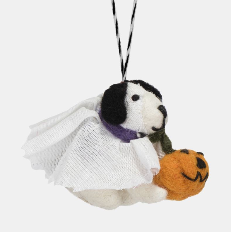 Felt dog ghost hanging decoration shown from the side, featuring a white gauze-style ghost costume, black ears, a purple collar detail, and an orange jack-o'-lantern pumpkin. Finished with a black-and-white hanging loop, ideal for Halloween décor, seasona