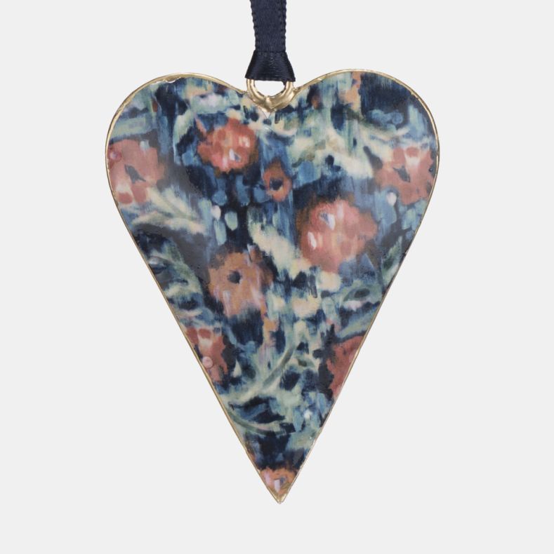 Metal heart-shaped hanging decoration featuring the Cotehele print, with a painterly floral design in blue, teal, pink, and cream tones. Finished with a gold-coloured edge and navy ribbon loop for hanging, ideal for seasonal décor, gifting, or home displa