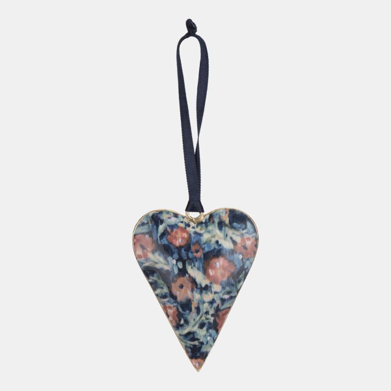 Metal heart-shaped hanging decoration featuring the Cotehele print, with an artistic floral design in shades of blue, pink, and cream. Finished with a dark blue ribbon loop for hanging, ideal for seasonal displays, home décor, or gifting.