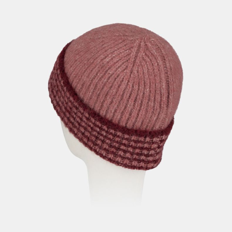 Pink ribbed knit beanie hat with a chunky textured turn-up brim in contrasting burgundy and pink tones, featuring a soft fluffy yarn and cosy winter design shown from a rear angled view.