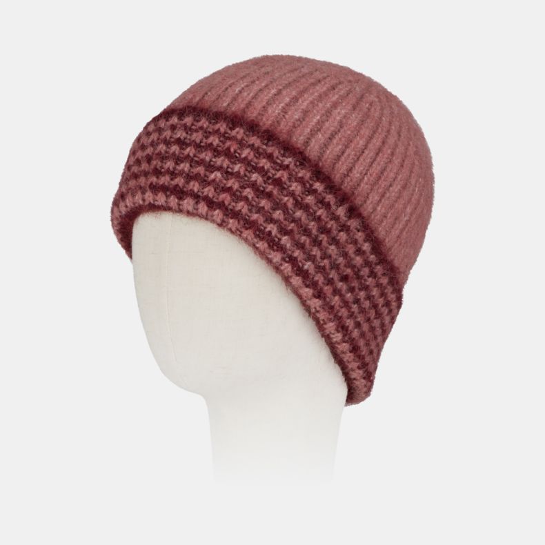 Pink ribbed knit beanie hat with a chunky textured turn-up brim in contrasting burgundy and pink tones, featuring a soft fluffy yarn and cosy winter design.