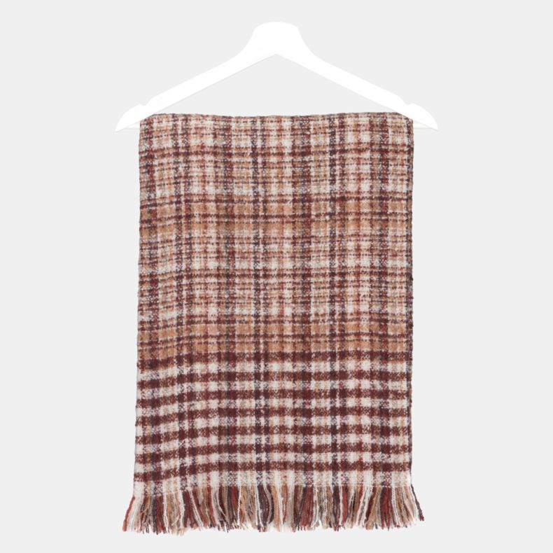 Rust and cream woven check scarf folded on a hanger, featuring an all-over plaid pattern in warm rust, cream and burgundy tones, a soft textured weave, and fringed ends.