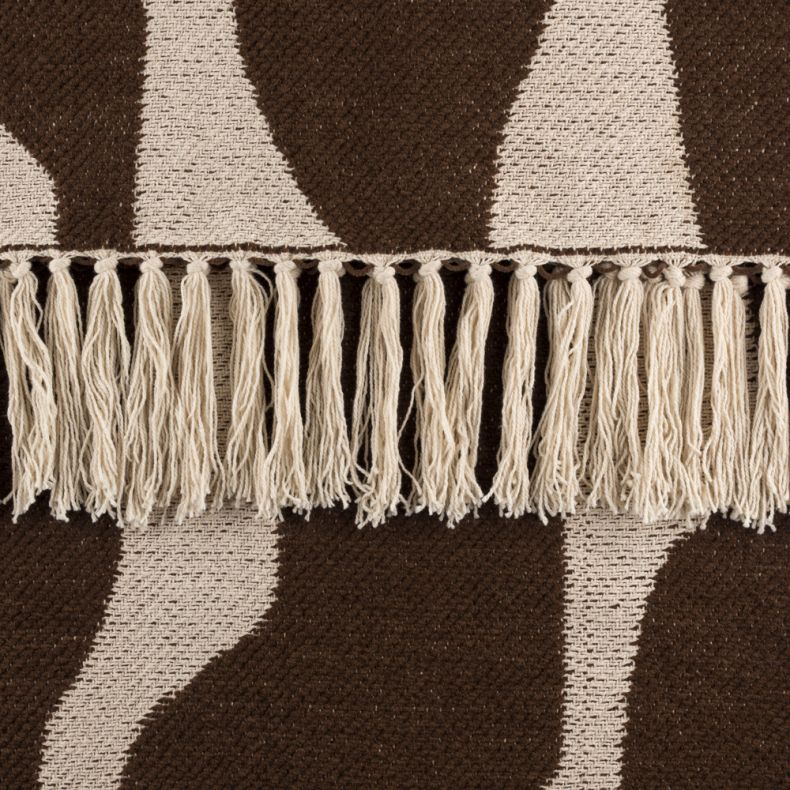 Close-up of the Recycled Alma Abstract Throw in chocolate brown and natural cream, featuring a bold woven abstract pattern and soft textured finish. Cream fringe tassels add decorative detail, while the cosy fabric showcases a contemporary design ideal fo