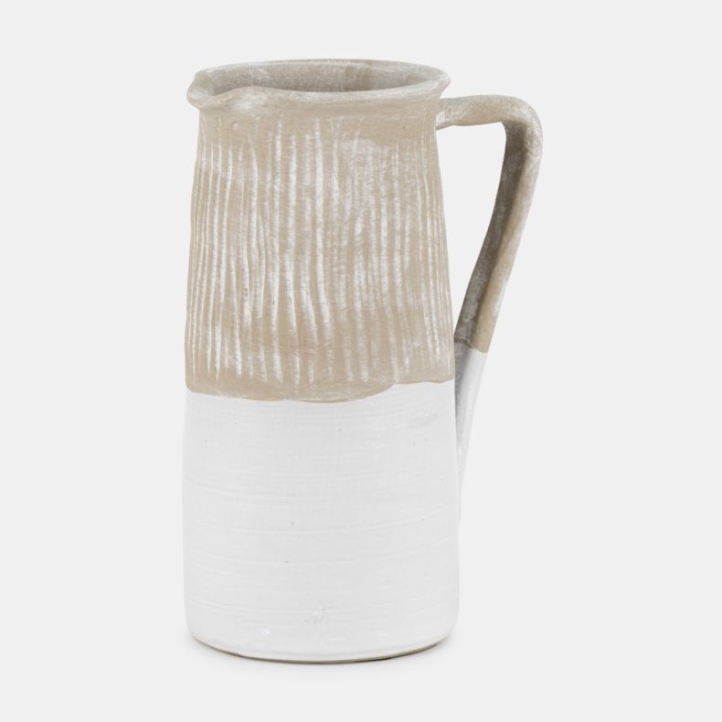 White Stoneware Jug with a rustic handcrafted appearance, featuring a textured ribbed upper section in a natural stone-effect finish and a smooth white glazed lower half. Complete with a curved handle and pouring spout, this decorative ceramic jug is idea