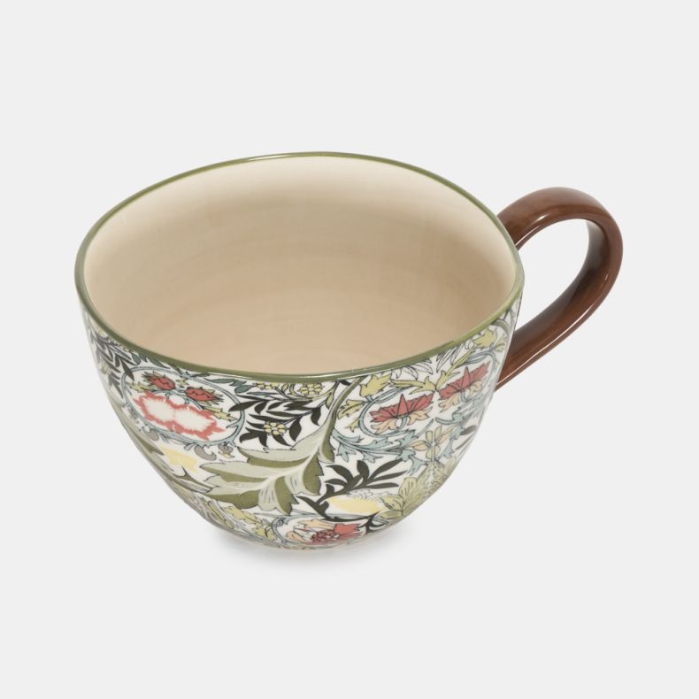 Top view of the Heritage Print Mug, showcasing an intricate heritage-inspired floral and foliage pattern in soft green, blue, cream and coral tones. The generously sized mug features a smooth cream interior and an elegant curved brown handle, combining vi