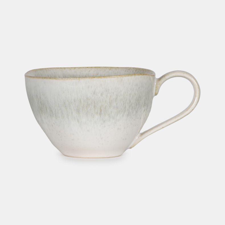 Speckled Mist Mug featuring a soft off-white reactive glaze with delicate speckled detailing and subtle mist-like tonal variations. Finished with a slender curved handle and gently tapered shape, this elegant stoneware mug brings a calm, contemporary feel