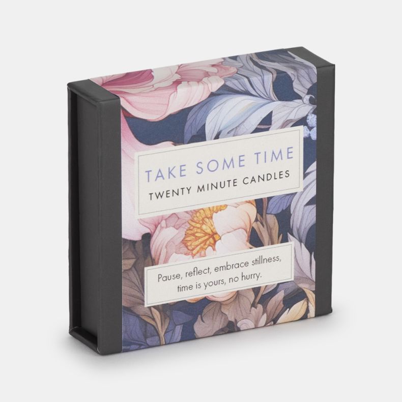 Decorative matchbox-style gift box featuring a floral design in soft pink, blue, and cream tones. Label reads “Take Some Time Twenty Minute Candles” with the message, “Pause, reflect, embrace stillness, time is yours, no hurry.”