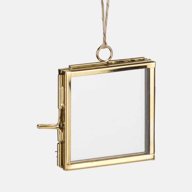 Gold-tone hanging photo frame decoration shown in a close-up view, featuring a square glass display case with polished metal edging, hinged opening, clasp fastening, and a natural twine hanging loop for displaying photographs, pressed flowers, or keepsake