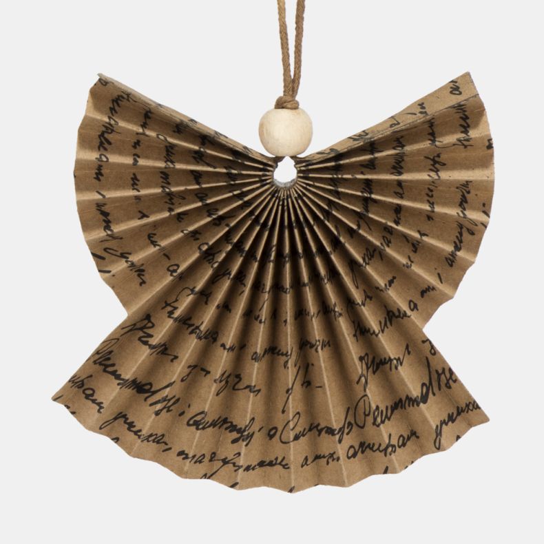 Paper angel Christmas hanging decoration shown in a close-up view, featuring a pleated kraft paper fan design with black handwritten script print, natural wooden bead detail, and a brown hanging cord for rustic festive décor.