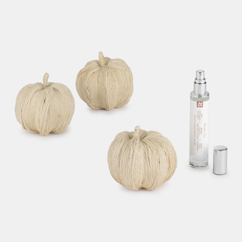 Set of three handmade cream rope pumpkins with a Pumpkin Chai fragrance spray in a clear glass bottle. Seasonal autumn décor accessories displayed on a light background, ideal for home decorating or gifting.