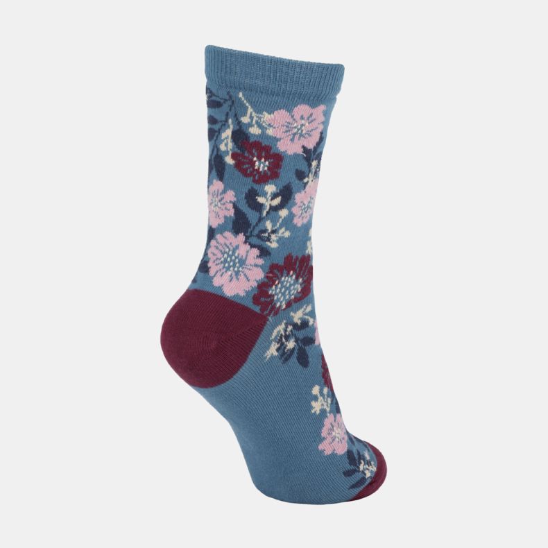 Blue floral ankle socks with pink and burgundy flower pattern, featuring a teal blue background, contrasting burgundy heel and toe, and a ribbed cuff shown from an angled side view.