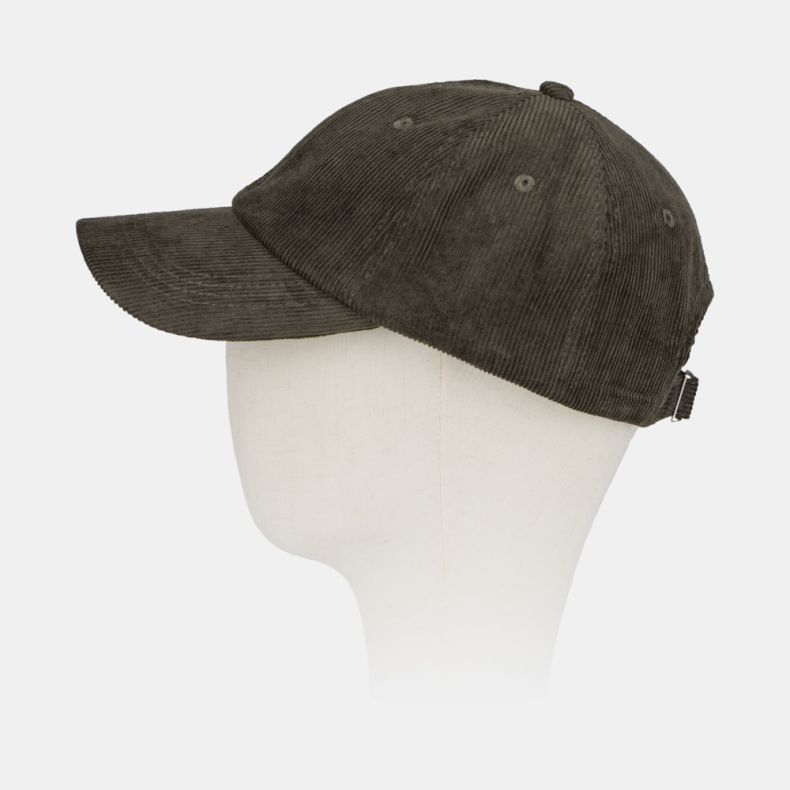Green corduroy baseball cap shown from an angled side view, featuring a classic six-panel design, curved peak, embroidered ventilation eyelets, adjustable back strap, and soft fine-wale cord texture.