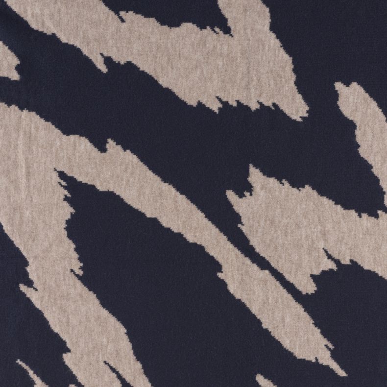 Navy and beige abstract patterned scarf fabric shown in a close-up view, highlighting the soft fine-knit texture and bold brushstroke-inspired design in contrasting navy blue and beige tones.