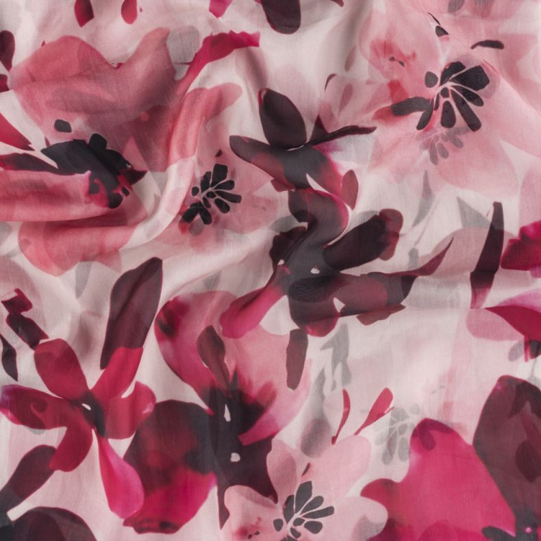 Pink floral scarf fabric shown in a close-up view, highlighting the lightweight semi-sheer texture and oversized watercolour-style flower print in shades of pink, fuchsia, burgundy and blush.