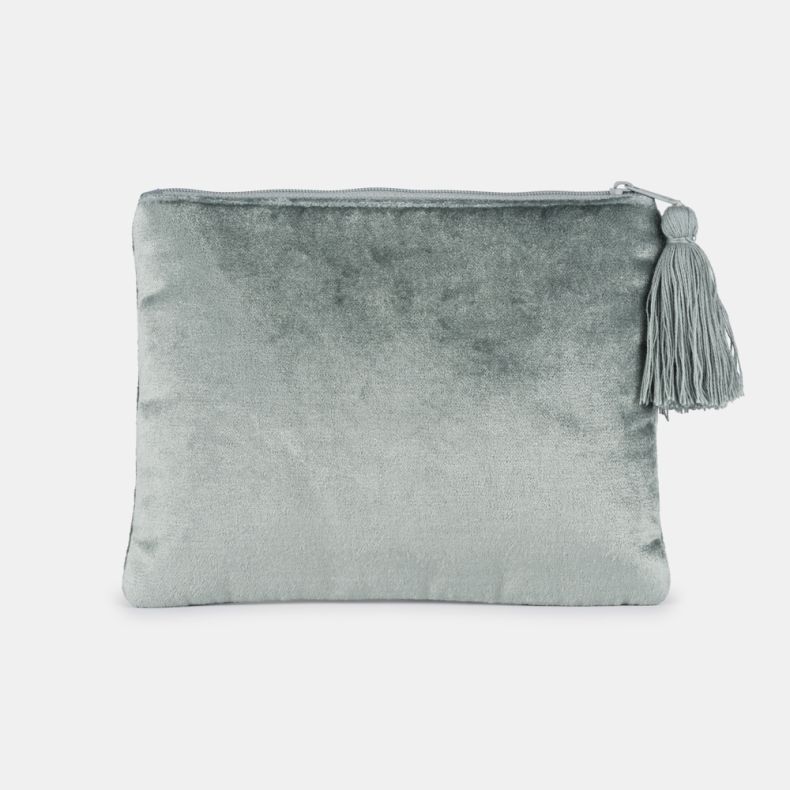 Light blue velvet cosmetic pouch shown from the reverse side, featuring a soft plain velvet finish, zip-top closure, and decorative tassel zip pull.