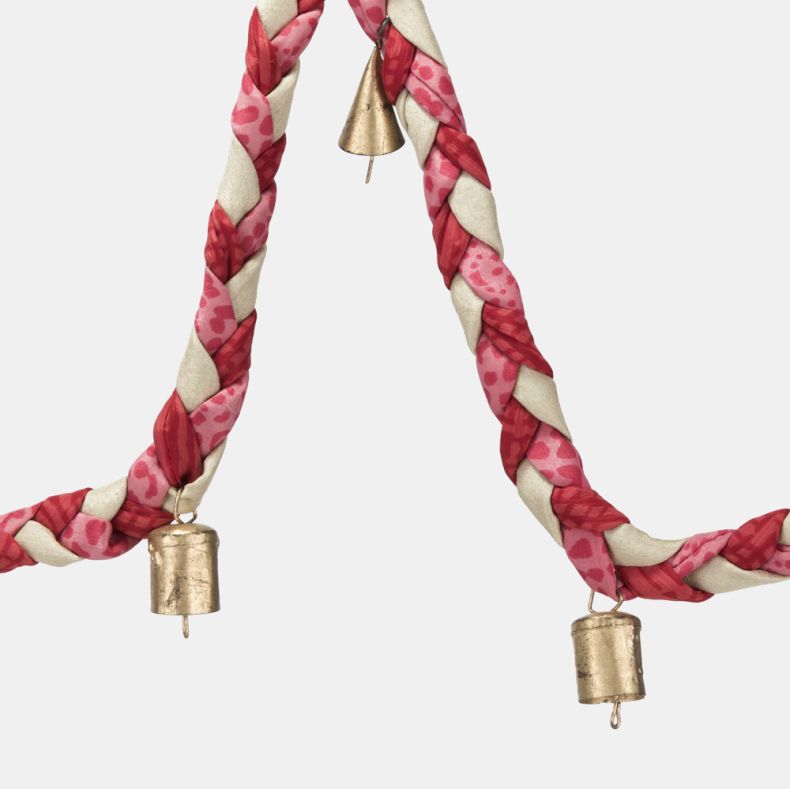Pink and cream braided fabric garland with decorative gold-tone bell charms, featuring a twisted patchwork-style design for festive seasonal home décor.

Copilot said: Pink and cream braided fabric garland shown in a close-up view, highlighting the twis