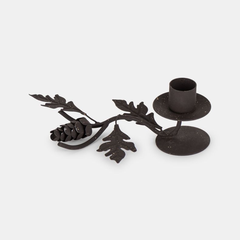 Rustic metal candle holder featuring an oak leaf and pine cone design with a dark aged finish, single taper candle cup, and woodland-inspired decorative branch detail.