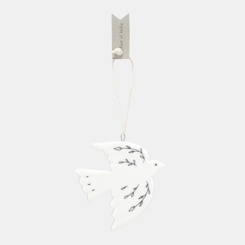 White ceramic dove Christmas hanging decoration shown from the reverse side, featuring delicate black botanical line illustrations, a smooth glazed finish, and a cream hanging ribbon, designed as a symbolic festive ornament for seasonal décor.