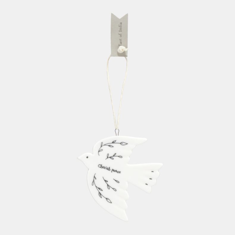 White ceramic dove Christmas hanging decoration featuring delicate black botanical line illustrations, the words “Cherish peace”, and a cream hanging ribbon, designed as a symbolic festive ornament for seasonal décor.