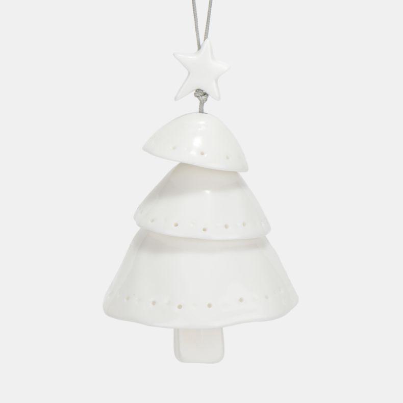 White ceramic Christmas tree hanging decoration shown in a close-up view, featuring a layered tiered tree design with a star topper, smooth glazed finish, subtle pierced dot detailing, and a silver hanging cord for festive seasonal décor.