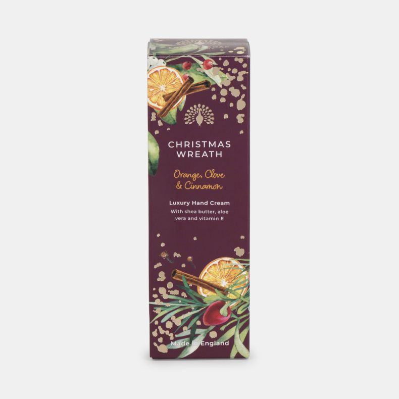 Christmas Wreath luxury hand cream in a burgundy gift box decorated with dried orange slices, cinnamon sticks, berries, greenery and gold accents. Orange, clove and cinnamon fragrance with shea butter, aloe vera and vitamin E. Made in England.