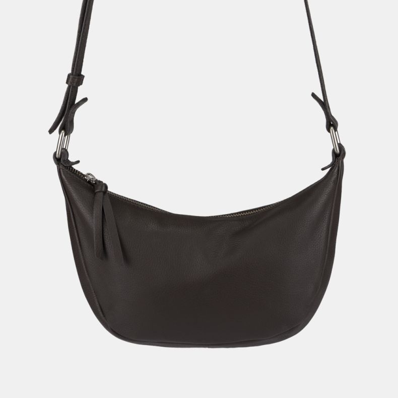 Dark brown leather-look crescent shoulder bag shown in a close-up front view, featuring a pebbled texture, zip-top closure with double pull tabs, adjustable shoulder strap, and silver-tone hardware.