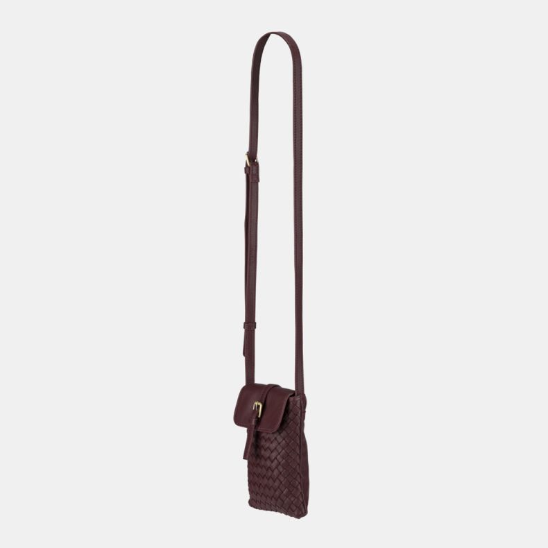 Burgundy woven crossbody phone bag with an adjustable shoulder strap, flap-over closure with gold-tone buckle detail, and basketweave texture, shown from an angled side view.