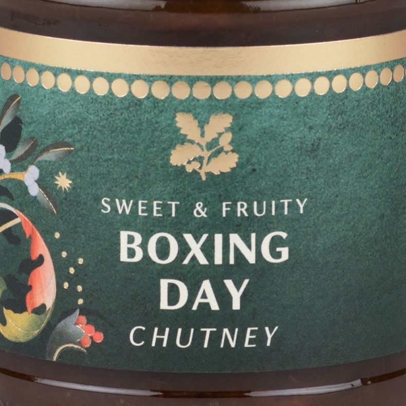 Close-up of a Boxing Day chutney jar label featuring festive botanical illustrations and the text “Sweet & Fruity Boxing Day Chutney”.