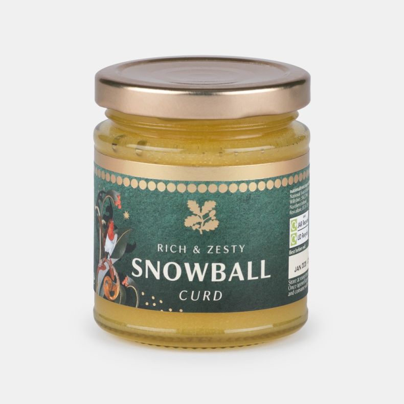 Jar of rich and zesty snowball curd with a festive green label featuring a robin illustration and the text “Rich & Zesty Snowball Curd”, presented on a light grey background.