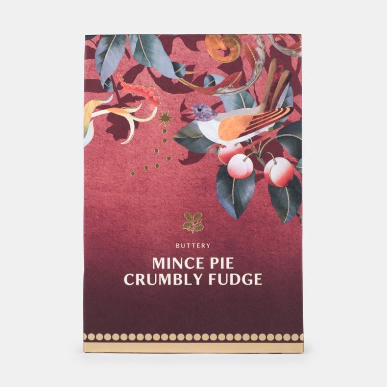 Buttery mince pie crumbly fudge in festive burgundy packaging featuring a bird, cherries, decorative botanical illustrations and gold accents, shown front on.