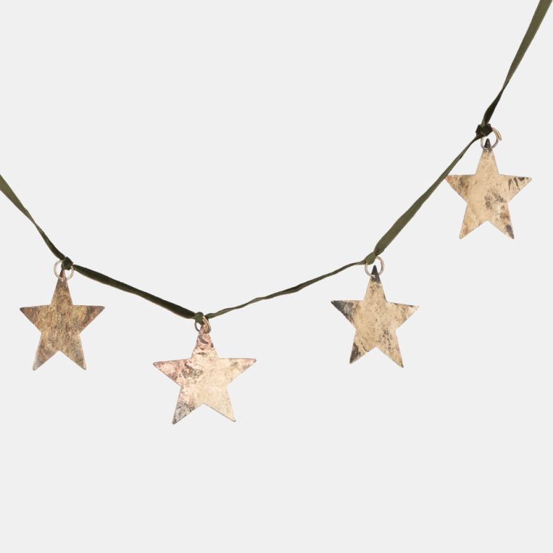 Decorative star garland featuring hammered metal star ornaments in a distressed antique gold finish suspended from an olive green ribbon, displayed to highlight the spacing, shape and rustic festive design.