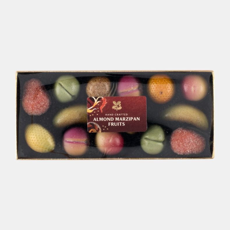 Hand crafted almond marzipan fruits assortment in a clear-lid gift box, featuring colourful fruit-shaped marzipan sweets including strawberries, bananas and assorted fruits, shown front on.