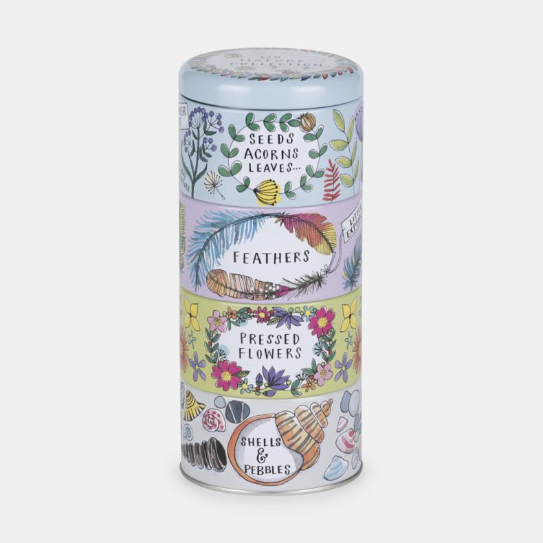Stackable nature-themed storage tin with four illustrated sections labelled “Seeds, Acorns & Leaves,” “Feathers,” “Pressed Flowers,” and “Shells & Pebbles.” Decorated with colourful botanical, feather, flower, shell, and pebble illustrations on a pastel b