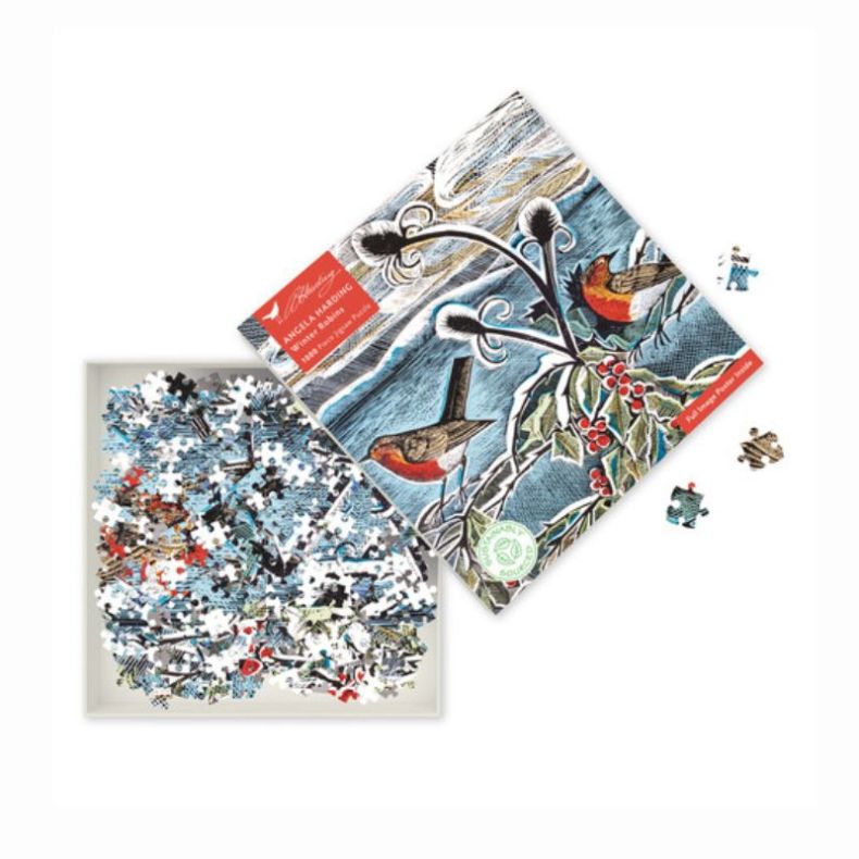 Angela Harding Winter Robins 1000-piece jigsaw puzzle displayed with the illustrated box lid and loose puzzle pieces. The artwork features two red-breasted robins among snow-covered branches, holly leaves and berries against a wintry blue landscape, showc