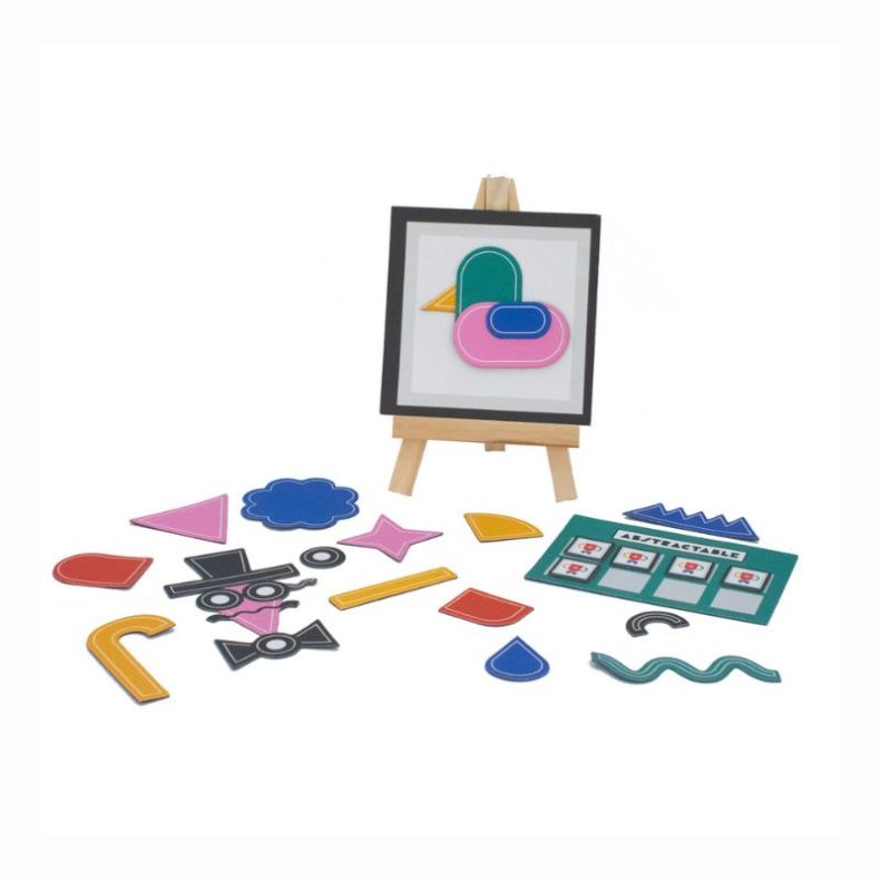 Abstractable game components displayed on a table, including colourful geometric shape tiles, a small easel with abstract artwork, and a challenge card. Bright, creative pieces used to build and guess abstract designs.