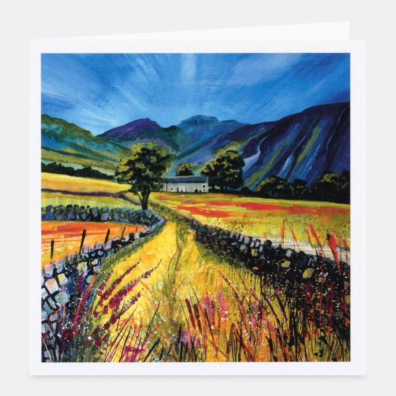 Landscape-themed notecard featuring vibrant artwork of a countryside scene with a winding path leading through golden fields towards a white farmhouse, framed by dry stone walls, trees and colourful wild grasses, with dramatic blue and purple mountains ri