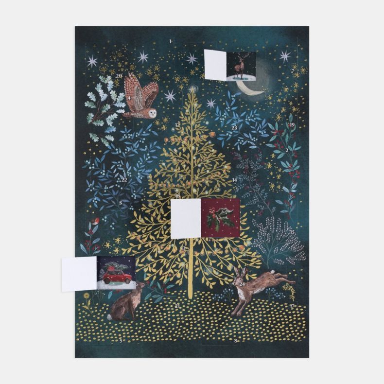 Illustrated advent calendar featuring a gold Christmas tree surrounded by decorative foliage, stars and seasonal motifs on a deep blue background, with several numbered advent doors opened to reveal festive illustrations including a stag, holly leaves and