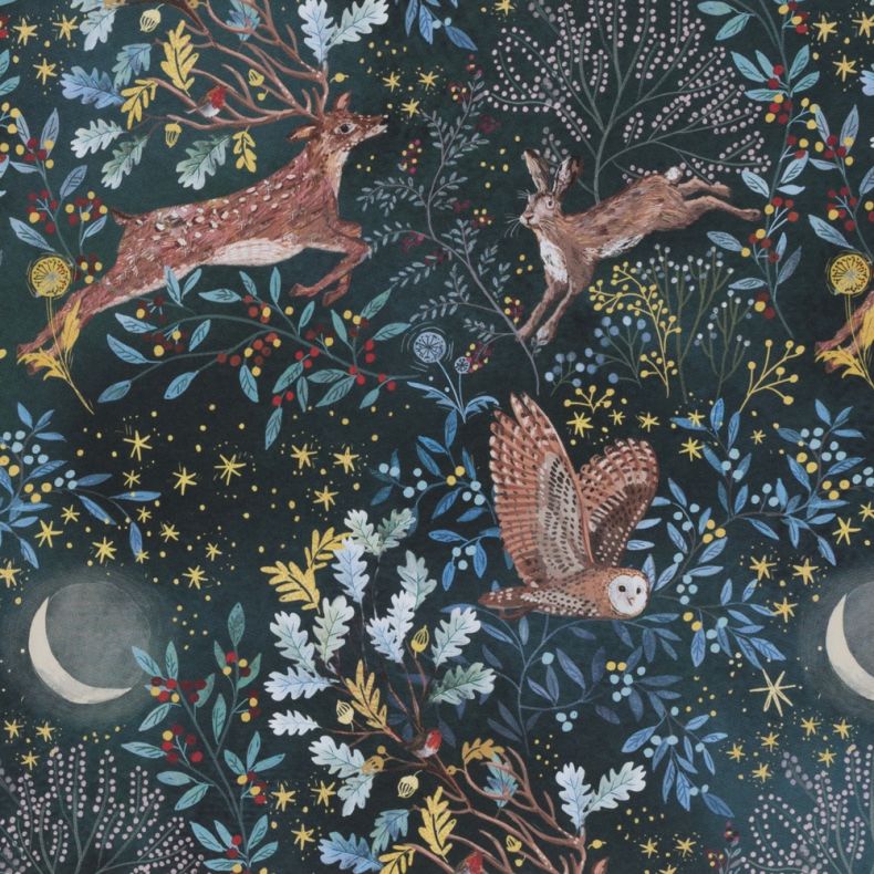 Christmas gift wrap design featuring a woodland scene with a stag, hare and barn owl among stylised foliage, berries and tree branches, set against a deep midnight blue background with stars and crescent moons, creating a repeating festive pattern inspire