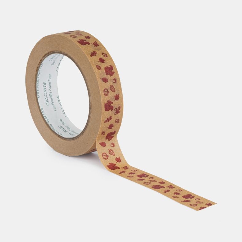 Roll of eco-friendly paper tape shown from an angled view with a length partially unrolled, featuring a repeating autumn woodland design with burgundy illustrations of squirrels, acorns, oak leaves, mushrooms, pumpkins and pinecones printed on a natural k