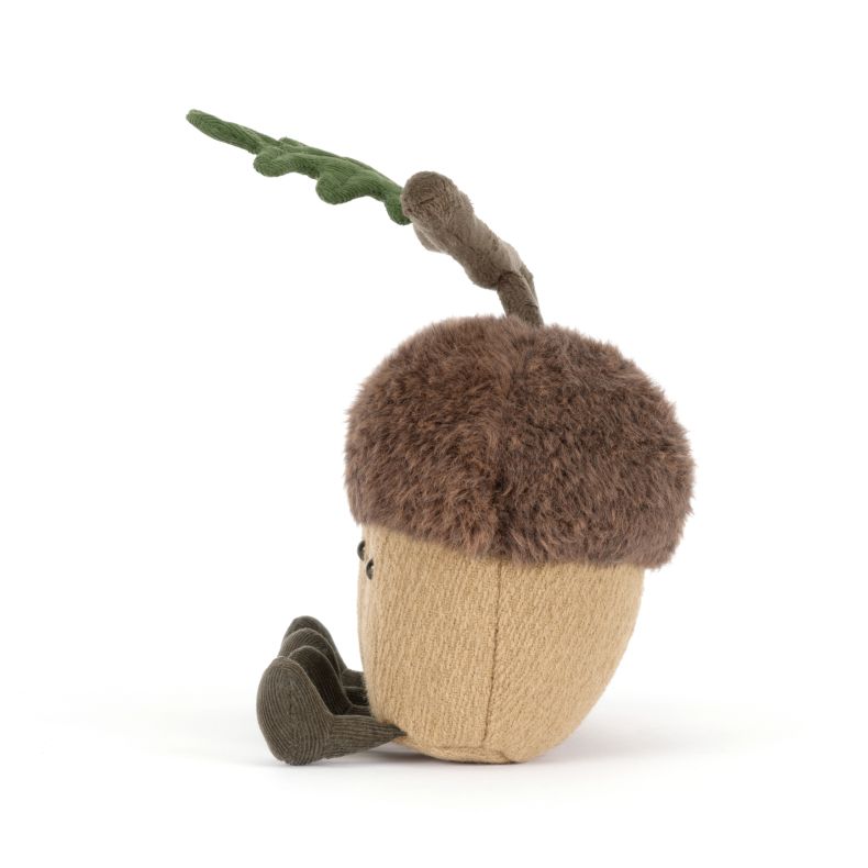 Jellycat acorn soft toy featuring two smiling plush acorns joined by a soft branch with green oak leaves. The cuddly woodland duo has fluffy brown caps, tan bodies, corduroy legs and embroidered facial details.