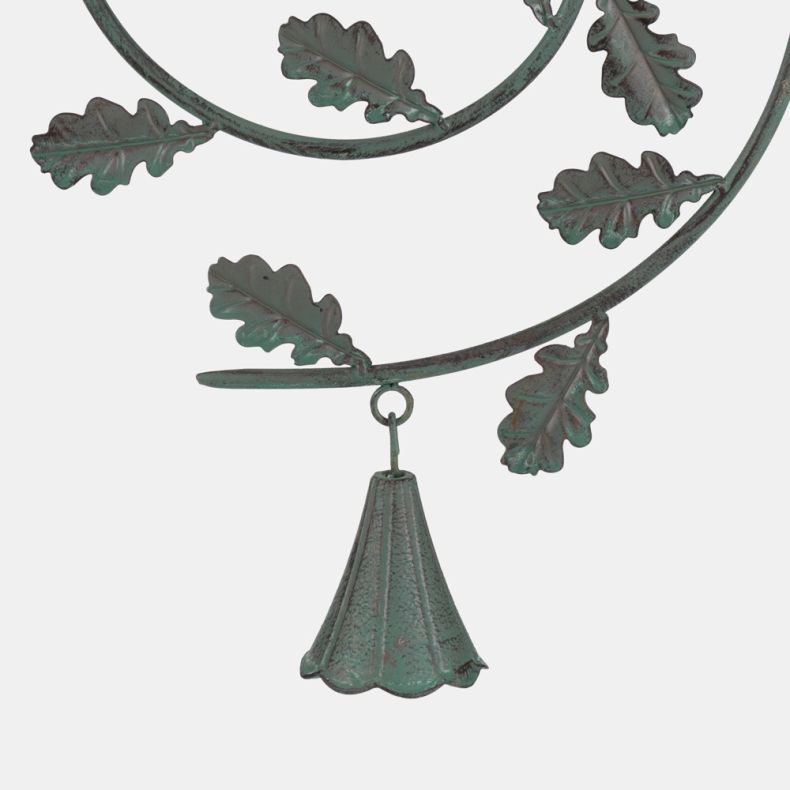 Decorative metal bird feeder tray with hanging bell-shaped ornament and oak leaf spiral detail in verdigris finish