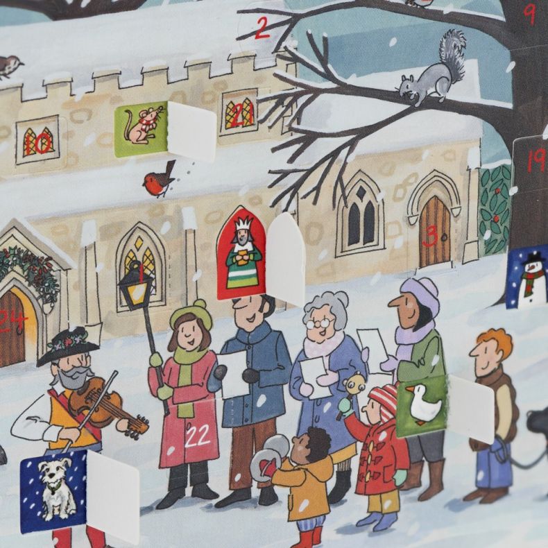 Close-up of winter village advent calendar with opening numbered doors, church illustration and festive carol singers in a snowy scene