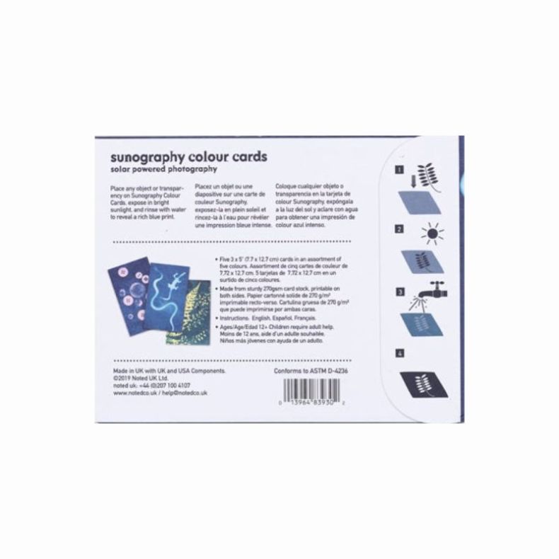 Back packaging of the “Sunography Colour Cards” solar‑powered photography kit, showing written instructions, contents details, safety information, and step‑by‑step diagrams illustrating how to place objects, expose the cards to sunlight, rinse with water,