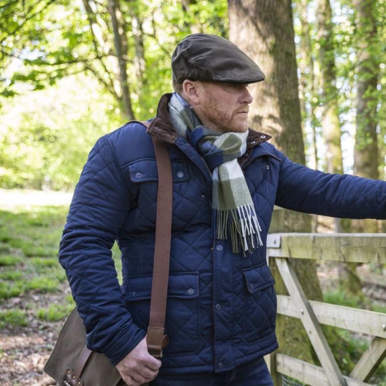 National Trust Waxed Flat Cap on a man in a woodland setting
