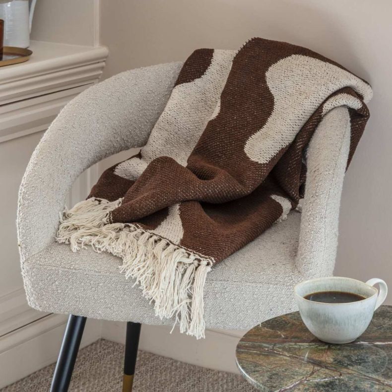 Alma brown and cream throw on a cream armchair