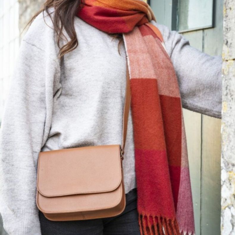 Red and orange knitted scarf with leather bag
