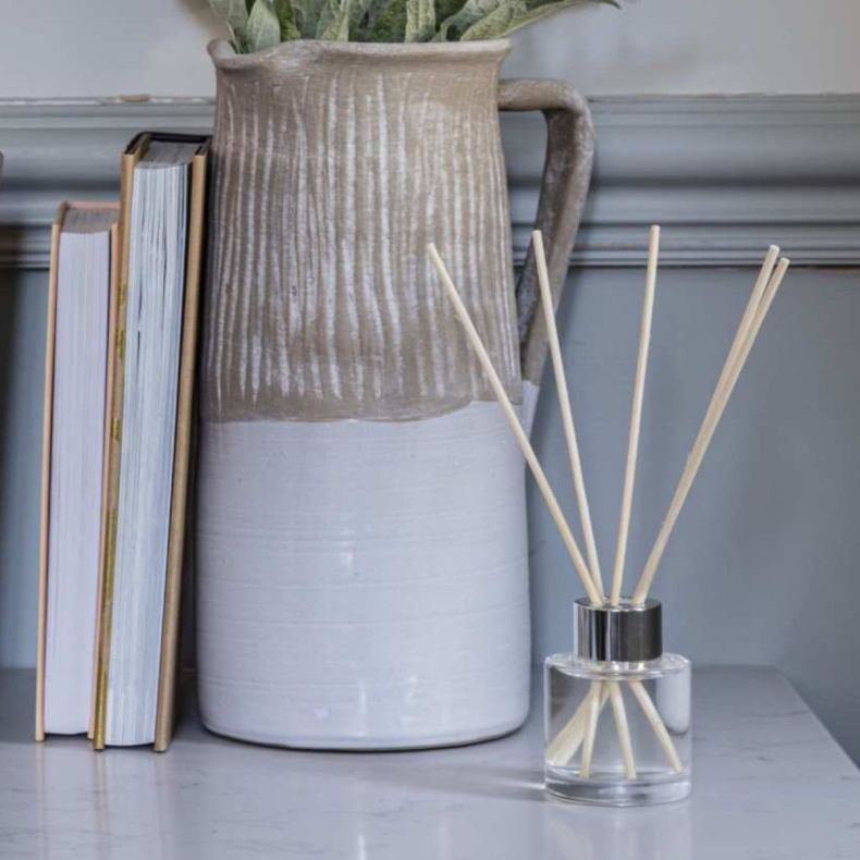 Clear glass diffuser on a marble shelf