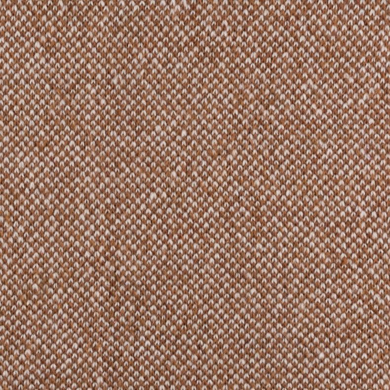 Close-up of a knitted throw blanket in a warm caramel and cream colourway, showcasing a textured woven pattern. The detailed fabric weave fills the frame, highlighting the blanket’s soft texture and craftsmanship.